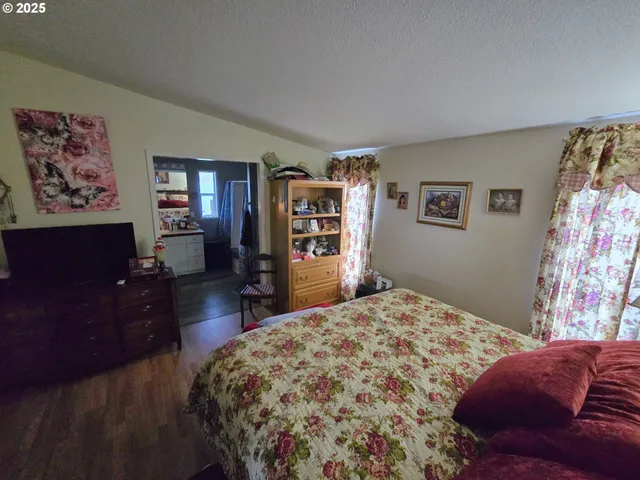 a bedroom with a bed dresser and a window