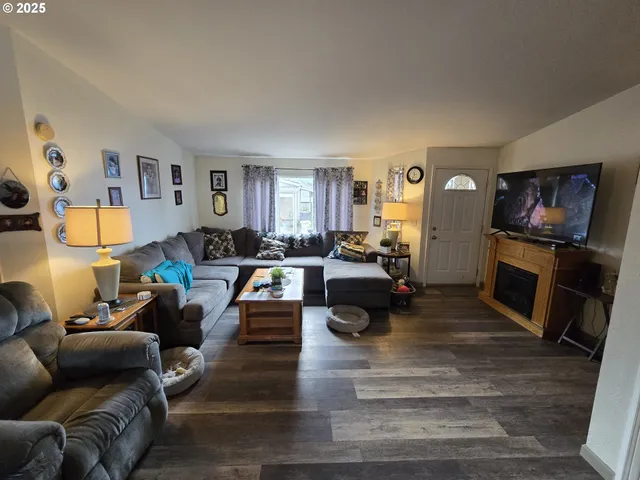 a living room with fireplace furniture and a flat screen tv