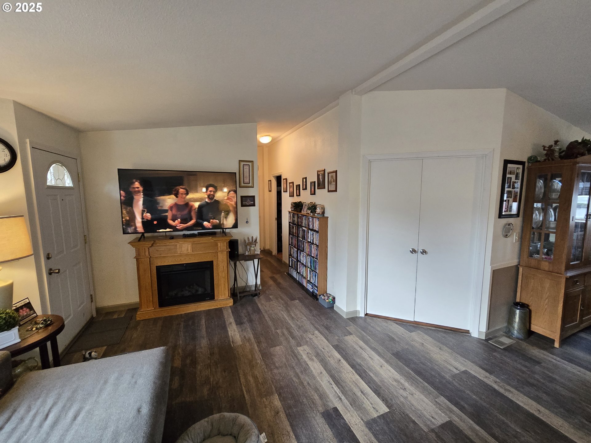 3200 Oak Terrace Drive, Unit 47 Lebanon, OR 97355 - Photo 7 of 24 a living room with furniture a flat screen tv and a fireplace