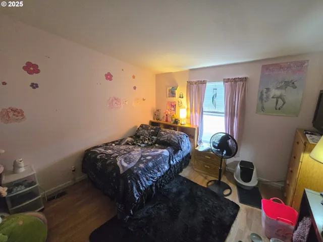 a bedroom with bed and a window