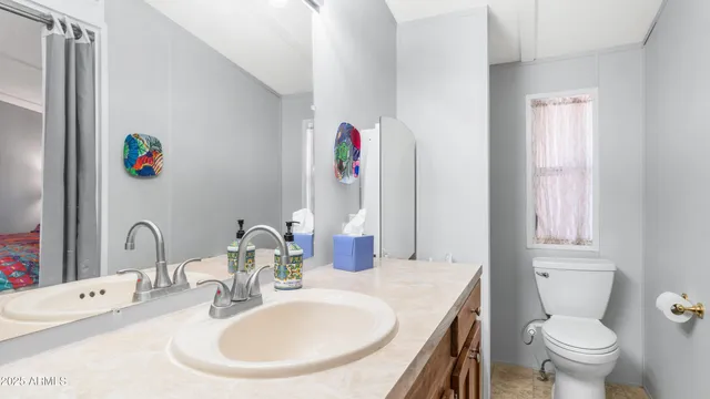 a bathroom with a sink a mirror and shower curtain