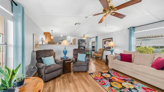 a living room with furniture and wooden floor