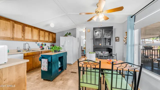 a kitchen with stainless steel appliances granite countertop a refrigerator a sink dishwasher and white cabinets with wooden floor