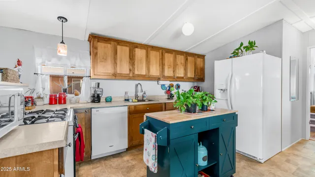 a kitchen with stainless steel appliances granite countertop a sink and a refrigerator