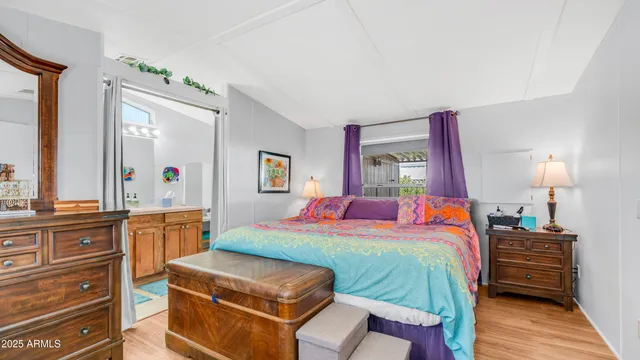 a bedroom with a bed and a mirror