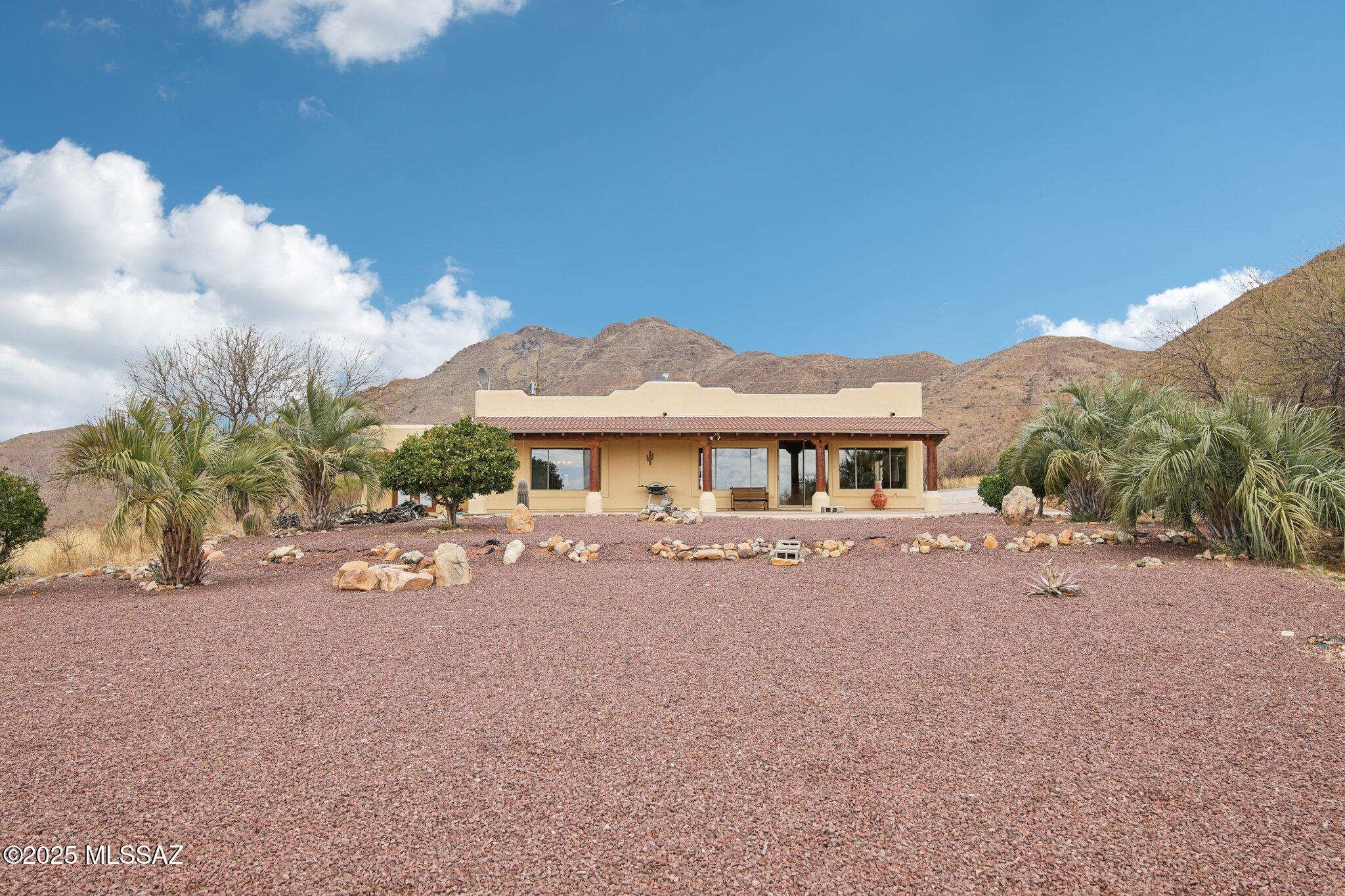 351 Camino Canoa Rio Rico, AZ 85648 - Photo 2 of 34 a front view of a house with a yard and sitting area
