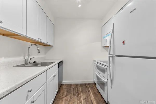 a kitchen with a sink and a refrigerator