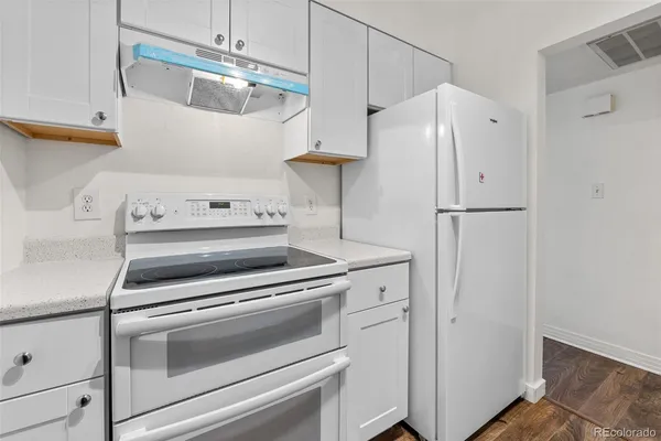 a kitchen with stainless steel appliances a refrigerator and a stove