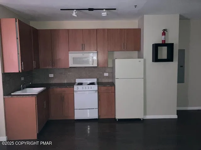 a kitchen with a refrigerator a stove a microwave and cabinets