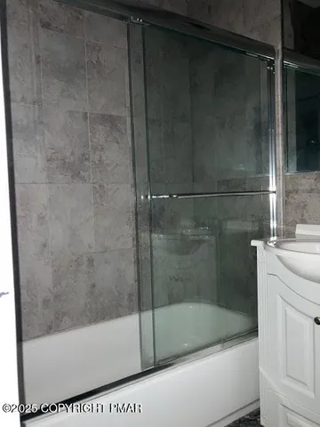 a bathroom with a bathtub and a shower