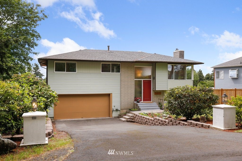 1015 Jones Avenue South Renton, WA 98057 - Photo 1 of 40 a front view of a house with a garden and garage