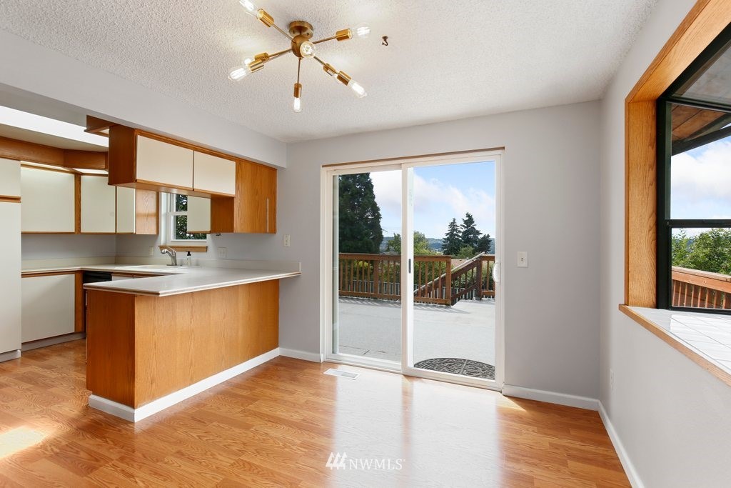 1015 Jones Avenue South Renton, WA 98057 - Photo 17 of 40 a kitchen with stainless steel appliances granite countertop a refrigerator and a sink