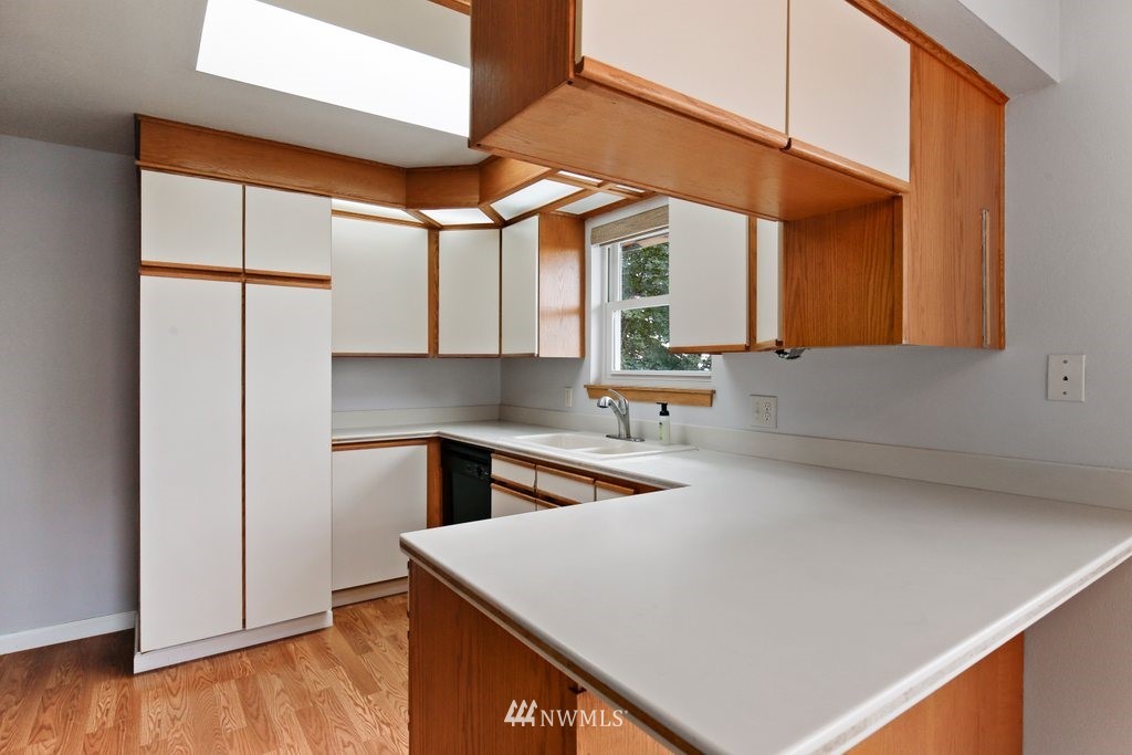 1015 Jones Avenue South Renton, WA 98057 - Photo 19 of 40 a kitchen with a sink a window and cabinets