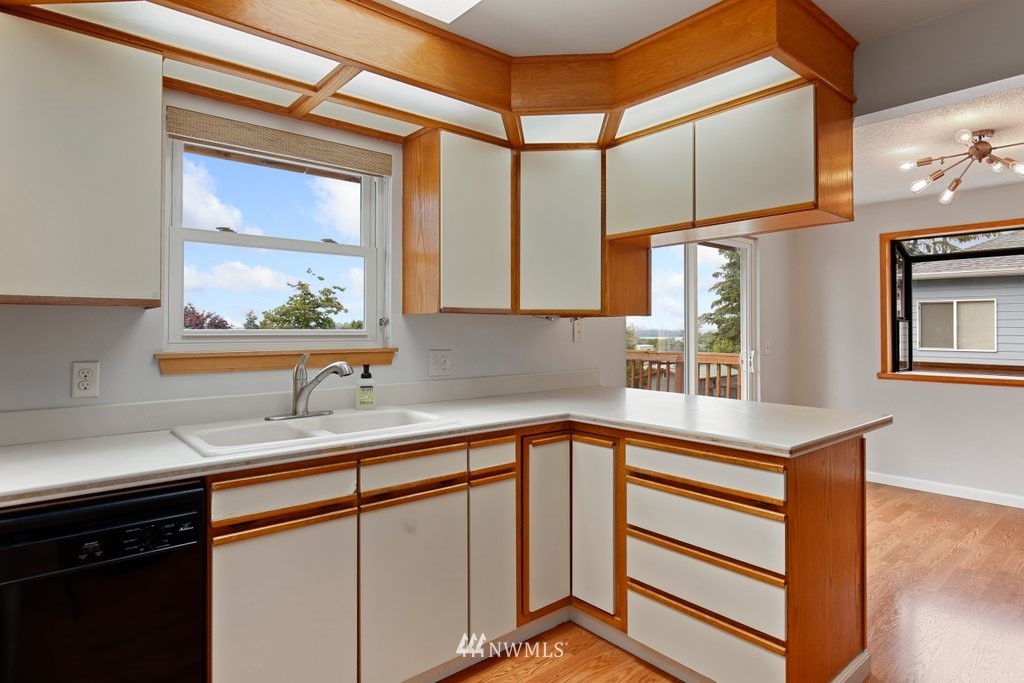 1015 Jones Avenue South Renton, WA 98057 - Photo 20 of 40 a kitchen with stainless steel appliances granite countertop a sink and a window