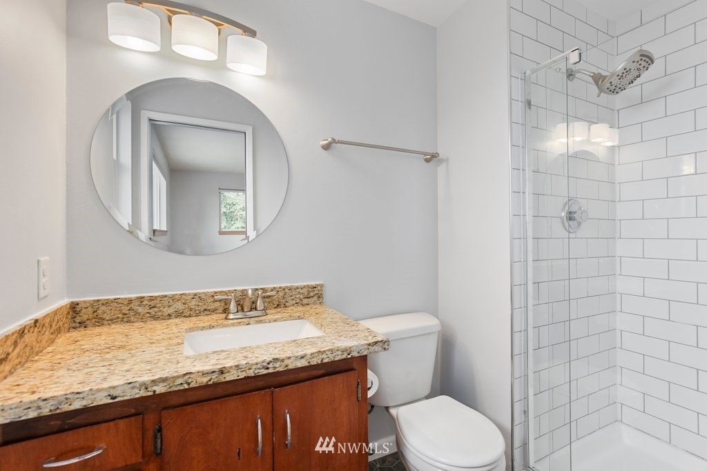 1015 Jones Avenue South Renton, WA 98057 - Photo 23 of 40 a bathroom with a granite countertop sink toilet and shower