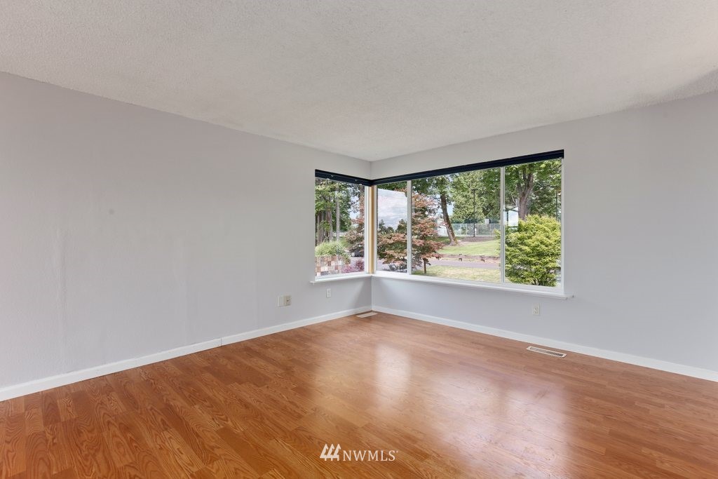1015 Jones Avenue South Renton, WA 98057 - Photo 10 of 40 a view of a big room with wooden floor and a window
