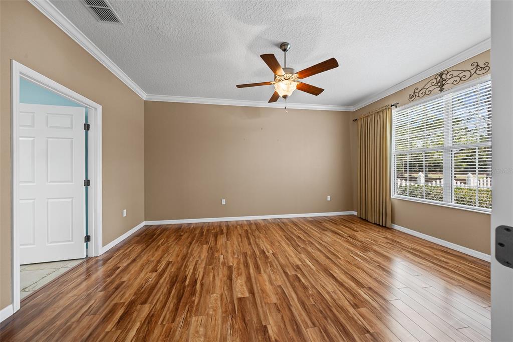 8713 Southwest 83rd Court Road Ocala, FL 34481 - Photo 11 of 23 wooden floor in an empty room with a window