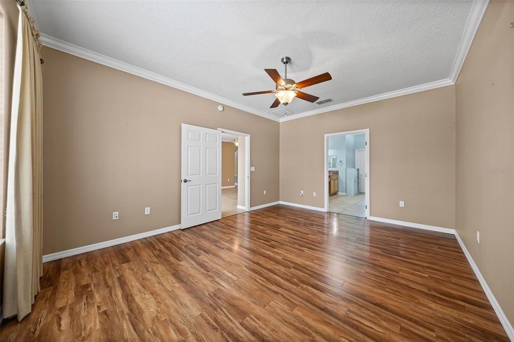 8713 Southwest 83rd Court Road Ocala, FL 34481 - Photo 12 of 23 a view of an empty room with wooden floor and a window
