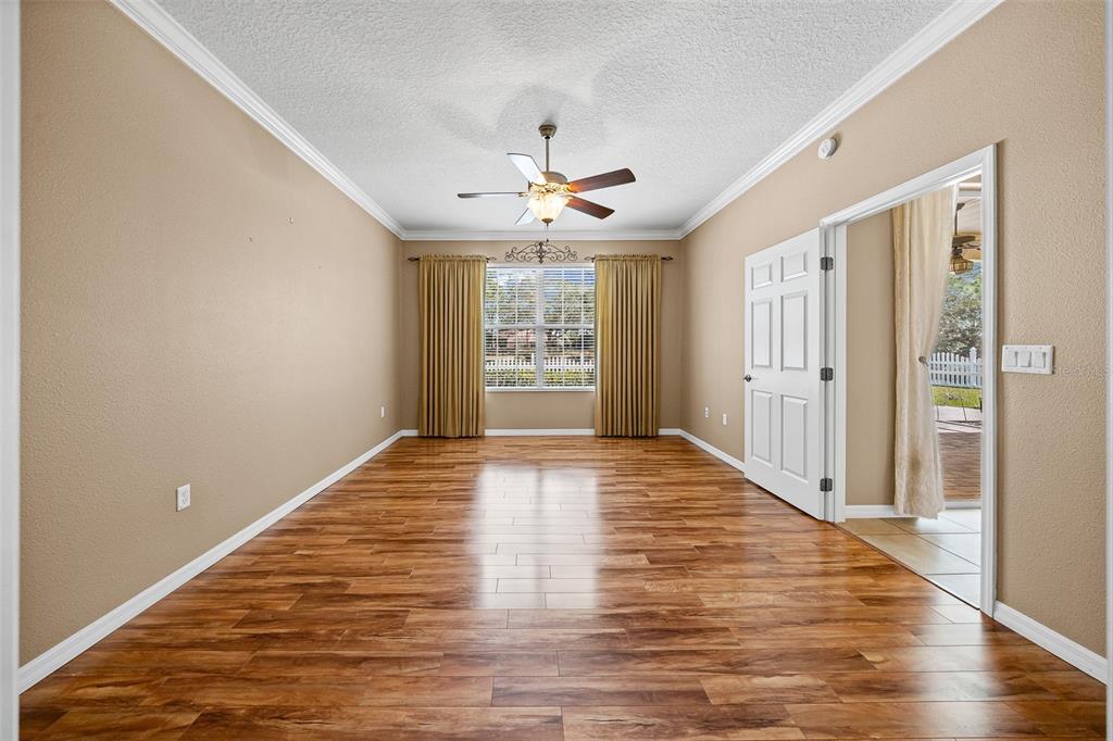 8713 Southwest 83rd Court Road Ocala, FL 34481 - Photo 13 of 23 wooden floor in an empty room with a window
