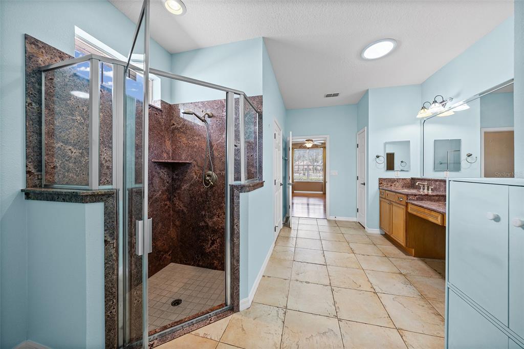 8713 Southwest 83rd Court Road Ocala, FL 34481 - Photo 16 of 23 a bathroom with a shower and a sink