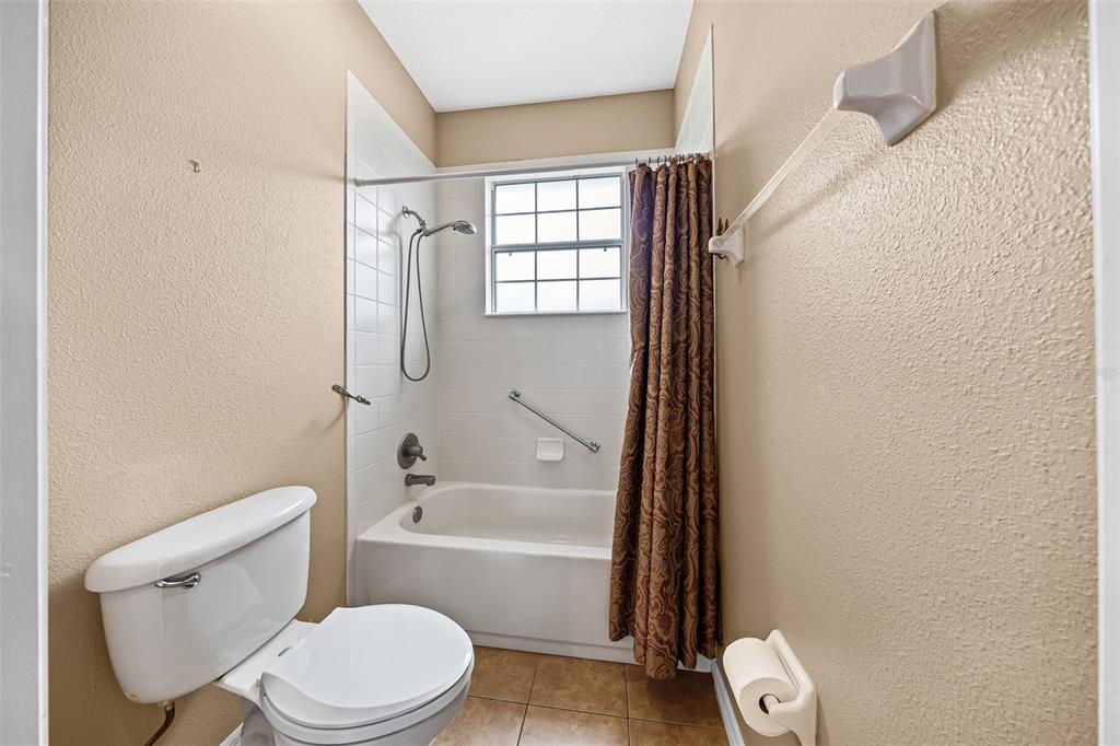 8713 Southwest 83rd Court Road Ocala, FL 34481 - Photo 19 of 23 a bathroom with a toilet and a bathtub