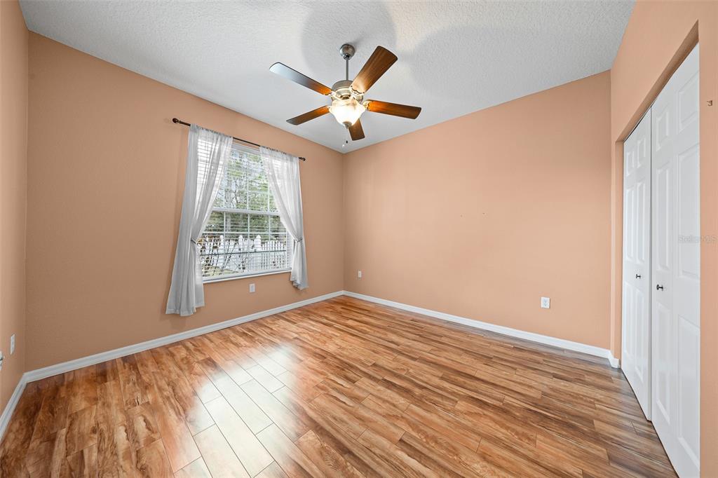 8713 Southwest 83rd Court Road Ocala, FL 34481 - Photo 20 of 23 wooden floor in an empty room with a window