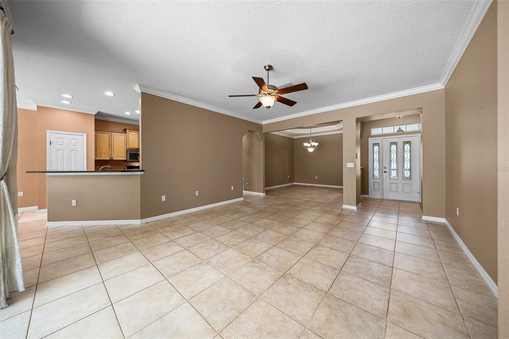 8713 Southwest 83rd Court Road Ocala, FL 34481 - Photo 5 of 23 a view of a livingroom with a chandelier fan and windows