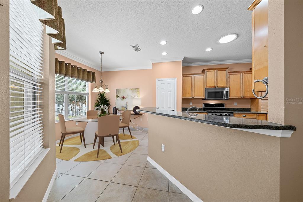 8713 Southwest 83rd Court Road Ocala, FL 34481 - Photo 10 of 23 a view of a kitchen with kitchen island granite countertop lots of counter top space and furniture