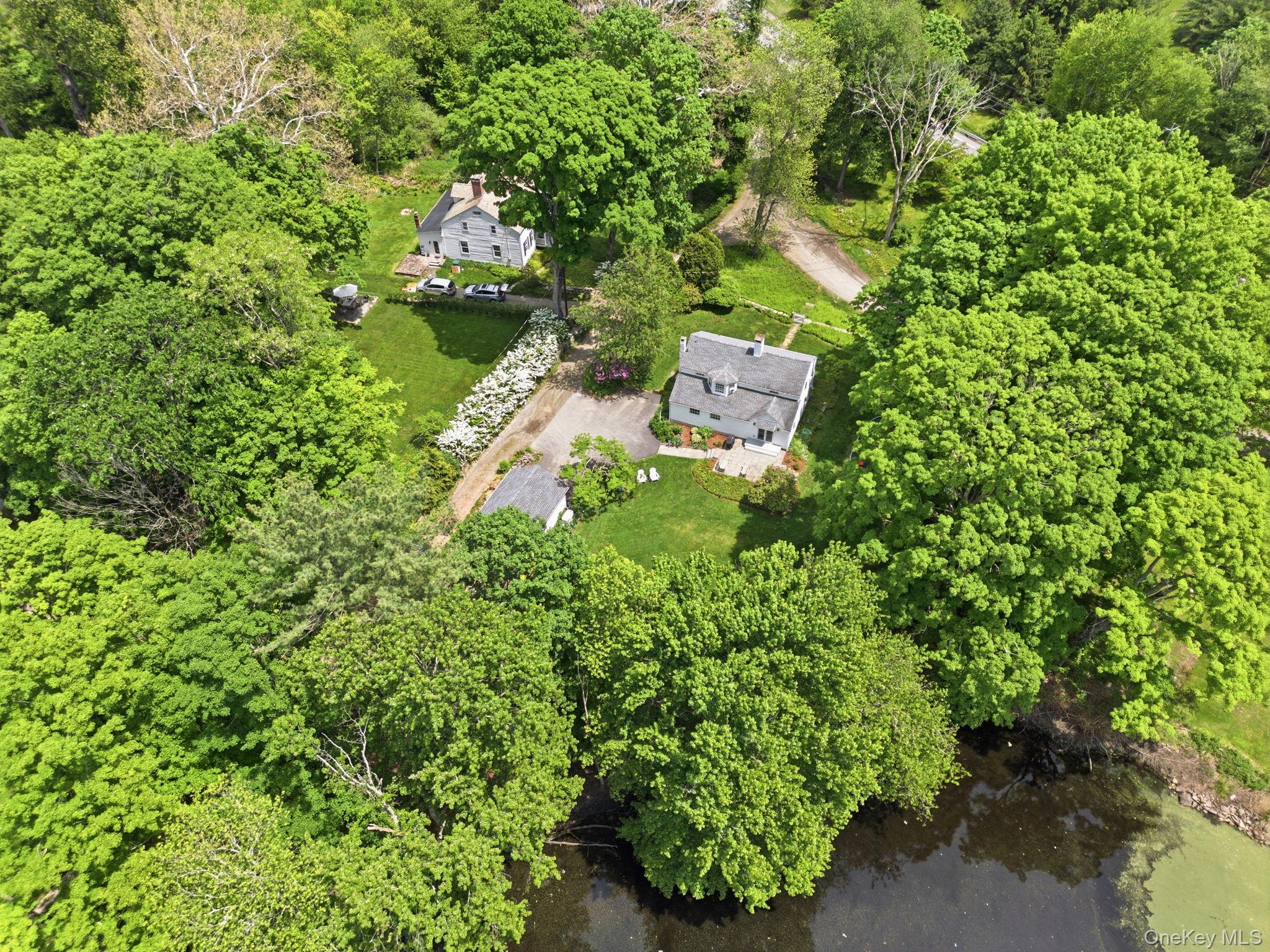 23 Pound Ridge Road Pound Ridge, NY 10576 - Photo 36 of 40 an aerial view of a house with a yard and garden