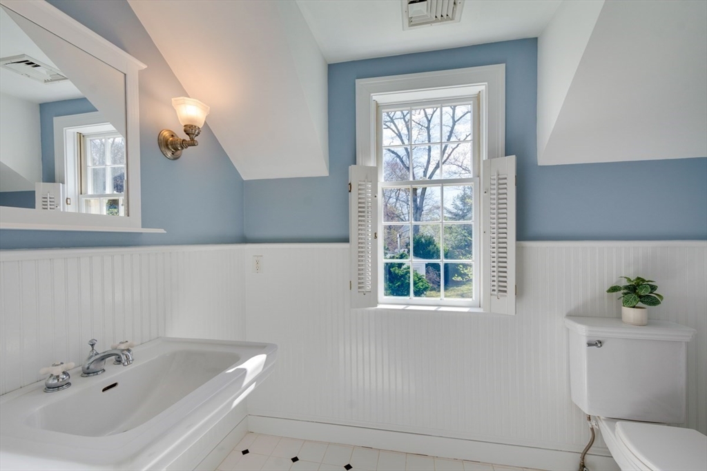 180 Highgate Street Needham, MA 02492 - Photo 20 of 31 a bathroom with a sink a toilet and a window