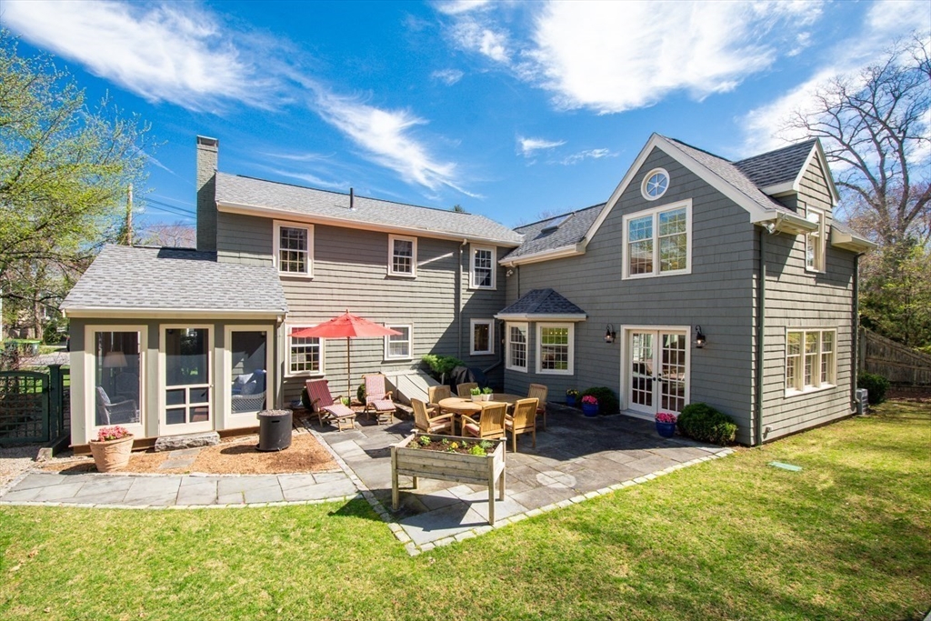 180 Highgate Street Needham, MA 02492 - Photo 2 of 31 a front view of a house with patio and a garden