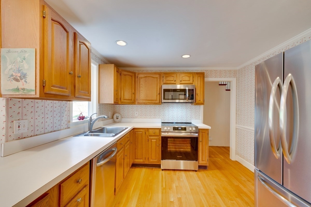 180 Highgate Street Needham, MA 02492 - Photo 9 of 31 a kitchen with stainless steel appliances granite countertop a sink a stove and refrigerator