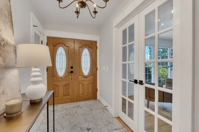 a view of a hallway with wooden floor and entryway