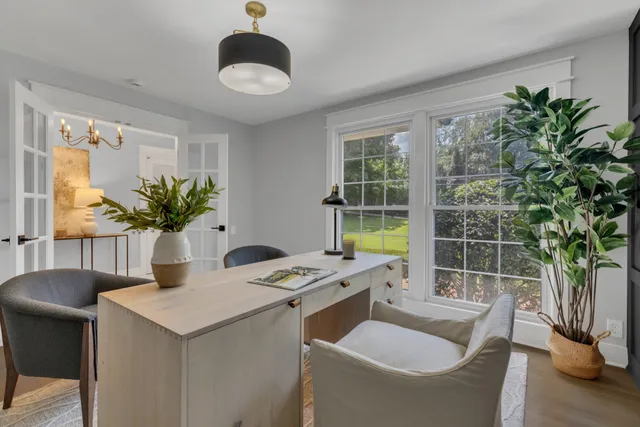 a view of a dining room with a table and chairs