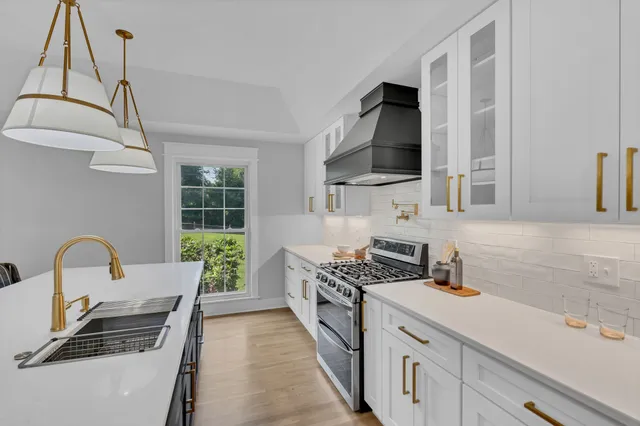 a kitchen with a stove a sink and a microwave