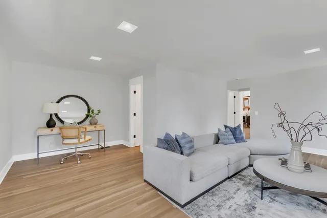 a living room with furniture a couch and a potted plant