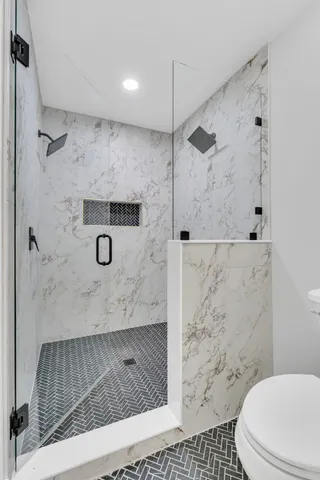 a bathroom with a shower and a toilet