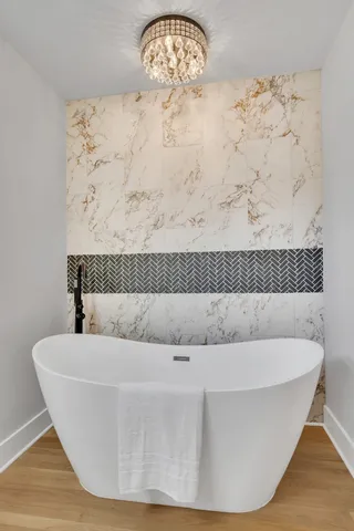 a white bath tub sitting in a bathroom
