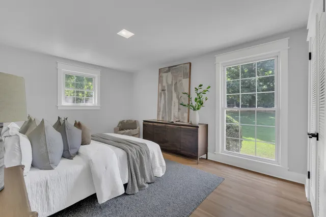 a bedroom with two beds and a window