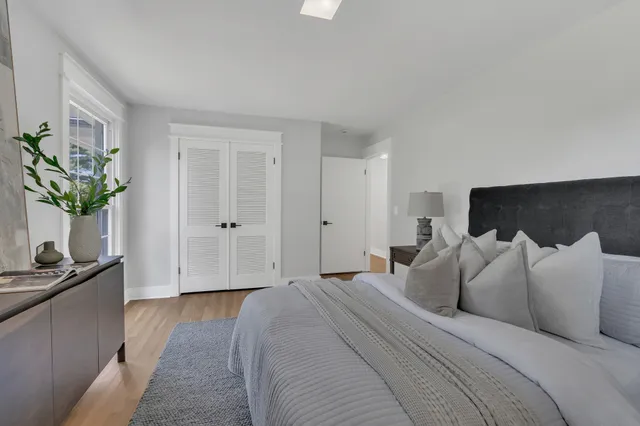 a bedroom with bed and window