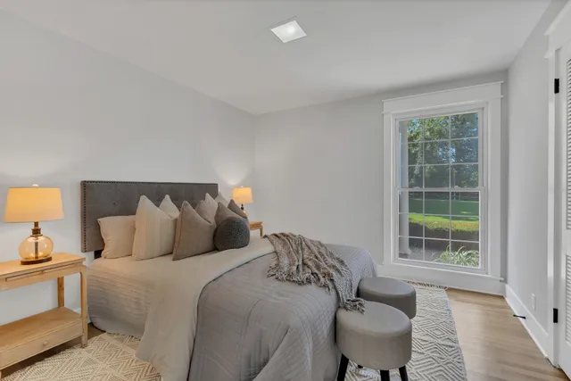 a bed sitting in a bedroom next to a window