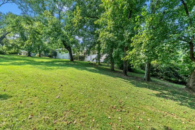 an aerial view of a house with yard swimming pool and outdoor seating