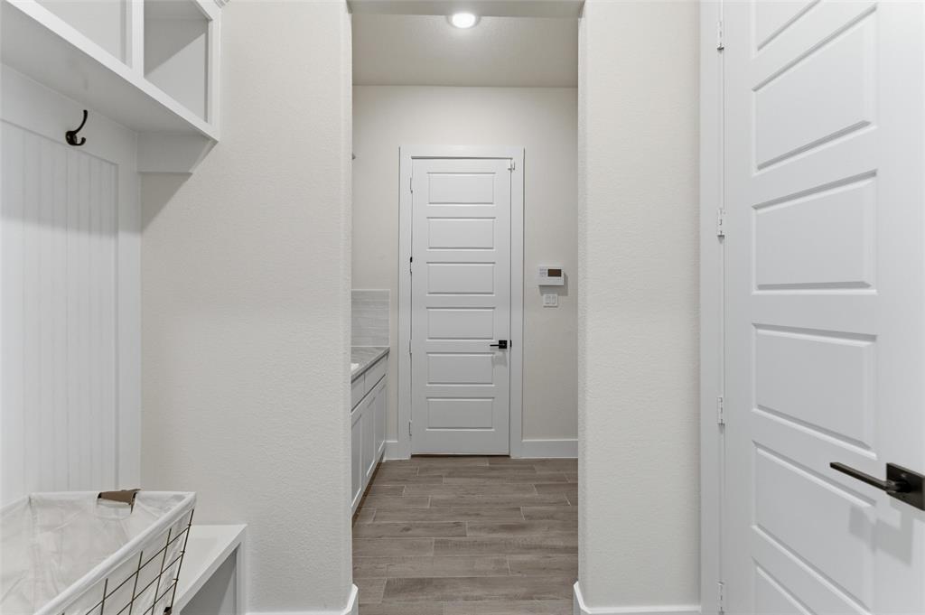 2433 Meteor Drive Krum, TX 76249 - Photo 8 of 29 Entryway mudroom area featuring built-in shelving, coat hooks, and a bench
