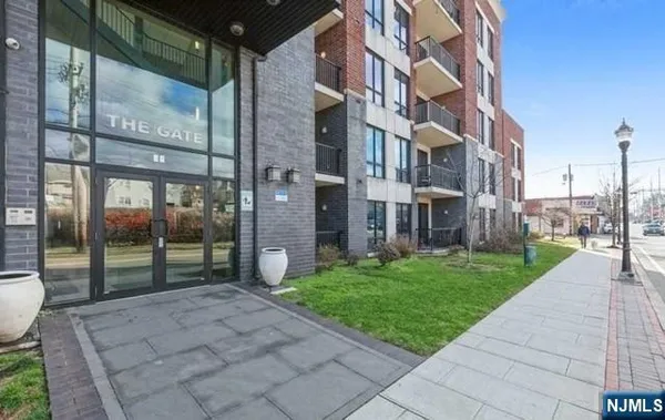a view of a brick building next to a yard