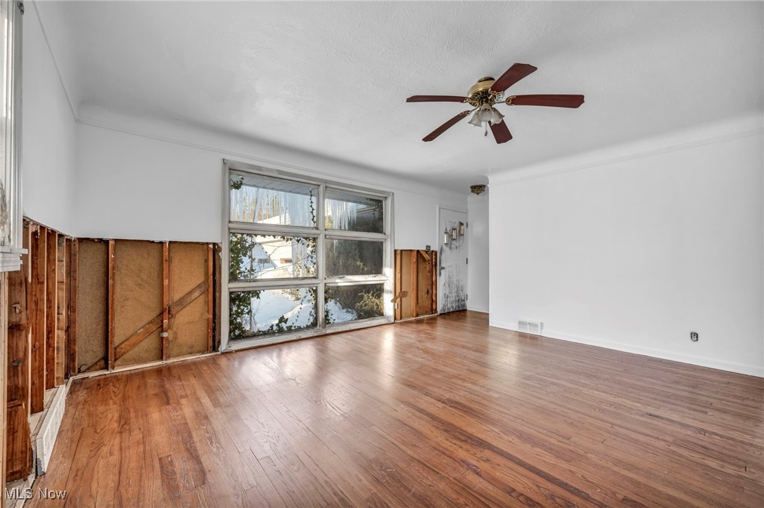 14750 Schreiber Road Maple Heights, OH 44137 - Photo 29 of 44 Unfurnished living room featuring wood-type flooring and ceiling fan