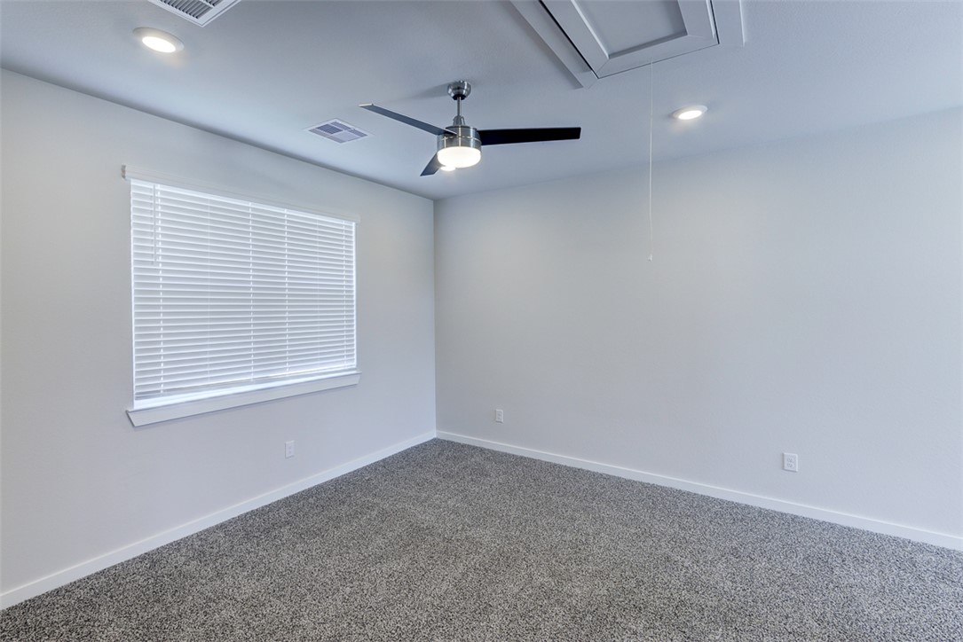 760 Double Mountain Road College Station, TX 77845 - Photo 17 of 26 en empty room with windows and ceiling fan