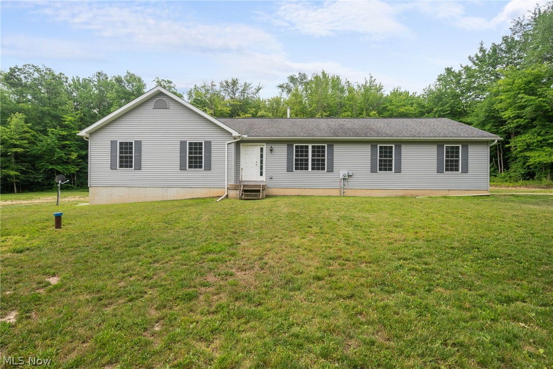 16985 Moseley Road Thompson, OH 44086 - Photo 1 of 22 View of front facade with a front lawn