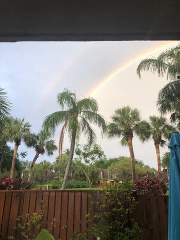 a view of balcony with a garden and trees