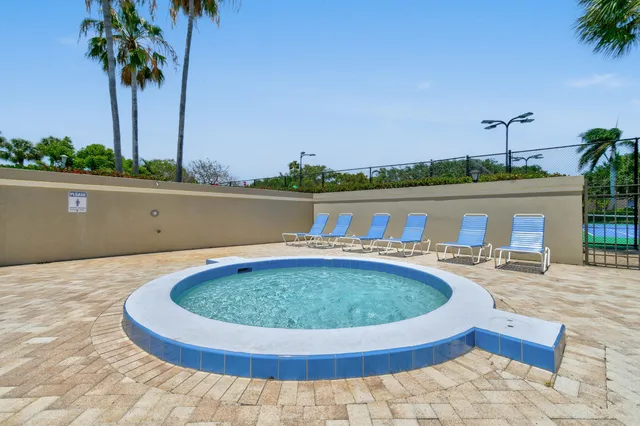 a view of swimming pool with seating space and lake view