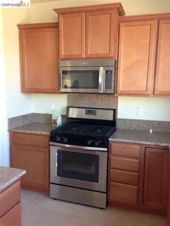 a kitchen with a stove and a microwave